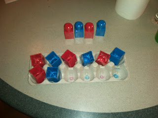 empty egg carton and red and blue mega blocks. Mega blocks laid out in a red blue pattern and pattern replicated in the egg carton