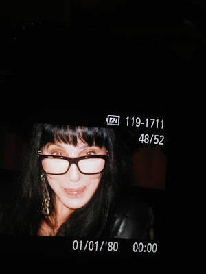 Cher, February 2013, sporting a pair of glasses and her real hair
