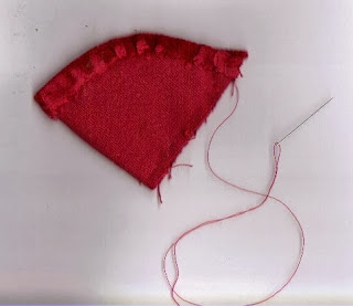 Red half circle stitched up side and around edge for ornament