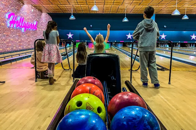 Children watching closely to see what score they will get at bowling