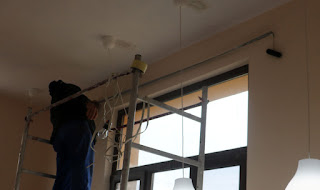 Bekir fitting the curtain rail in Room 13 Bekir fitting the curtain rail in Room 13