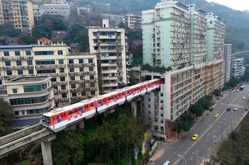 A Train In China's Mountain City (Chongqing) Runs Through An Apartment Building