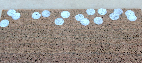 Keep adding white dots to your plain doormat and eventually you'll have a polka dot holiday door mat!