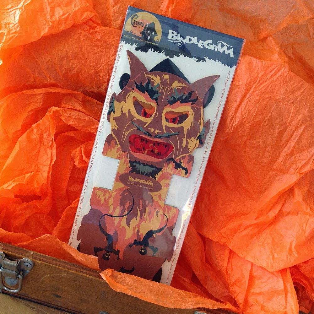 Orange crepe paper and wooden box display paper devil gift-box candy-cotainer lantern in a vintage-style Halloween design.