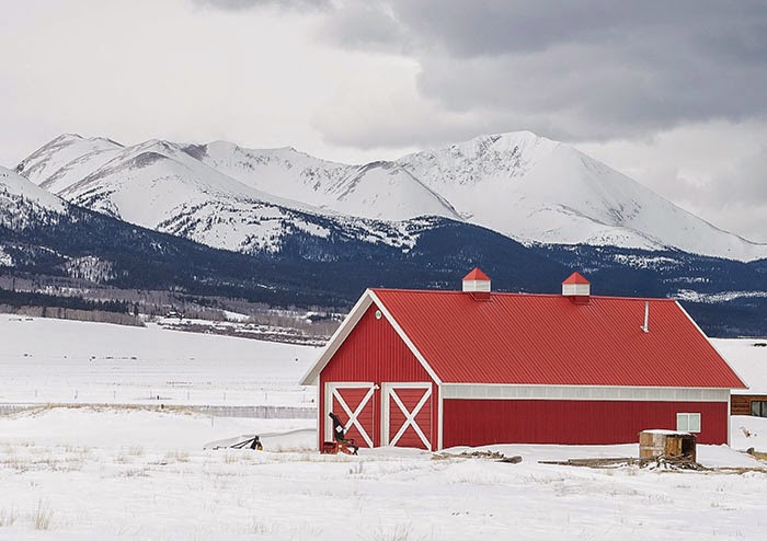Mount Guyot from Highway 285 with red barn in winter