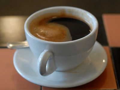 A delicious, steaming cup of Americano coffee.