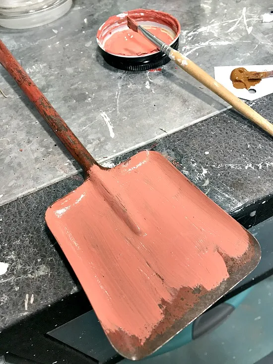 vintage shovel painted with orange chalky paint