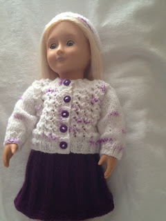 http://www.craftsy.com/pattern/knitting/toy/cardigan-and-skirt-set-18-inch-dolls-/169019