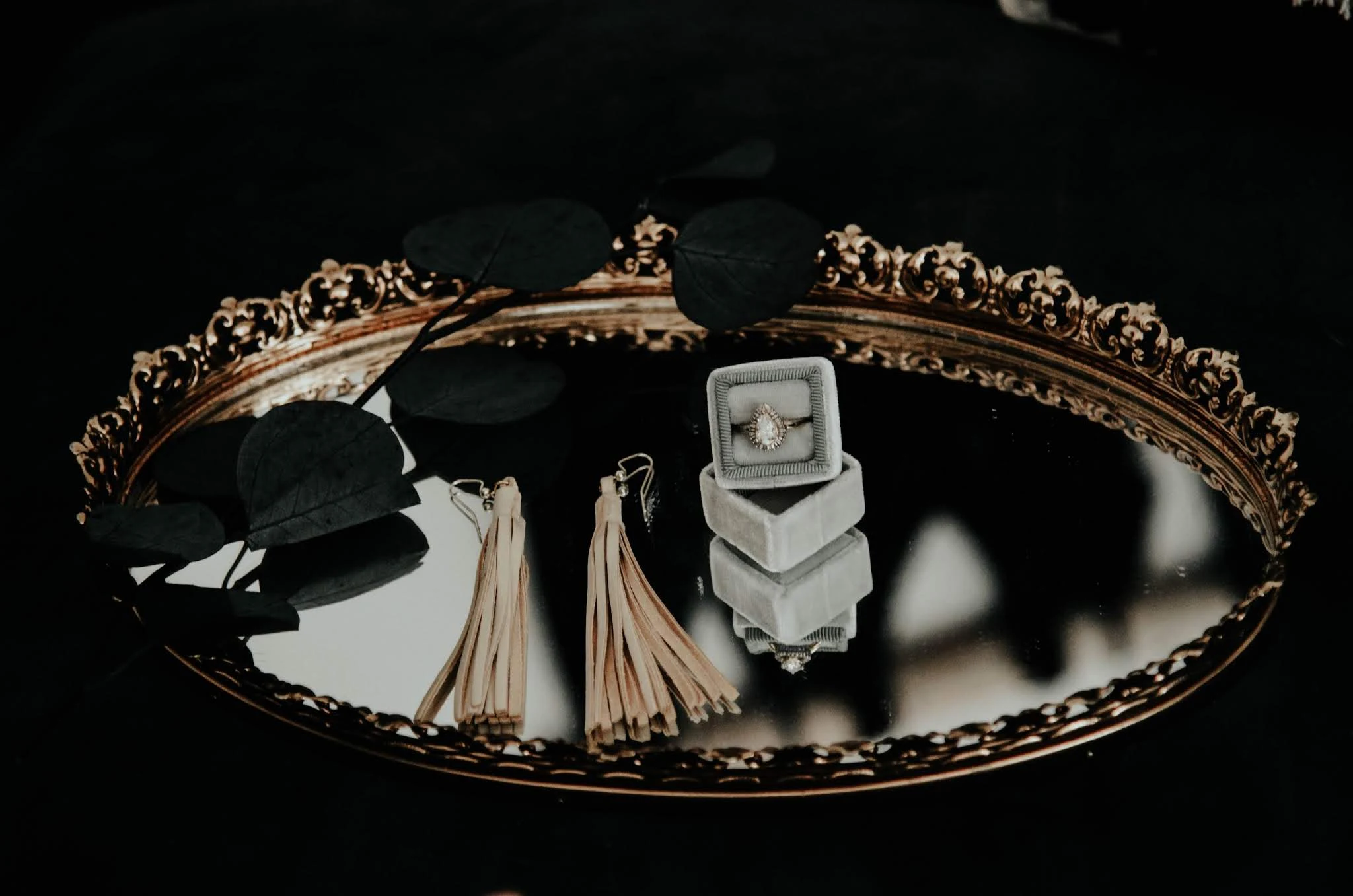 various vintage jewelry pieces laying on top of a mirror