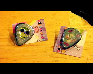 Glittery guitar pick pins, one with a skull the other with a music note and stickers Glittery guitar pick pins, one with a skull the other with a music note and stickers