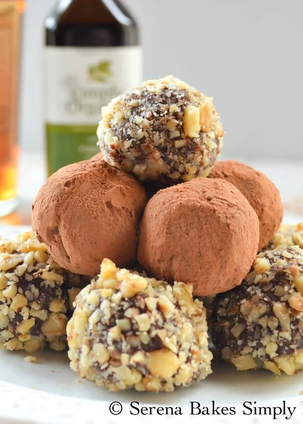 Chocolate Rum Truffles candy recipe covered in cocoa powder and nuts from Serena Bakes Simply From Scratch are a favorite boozy truffle recipe.