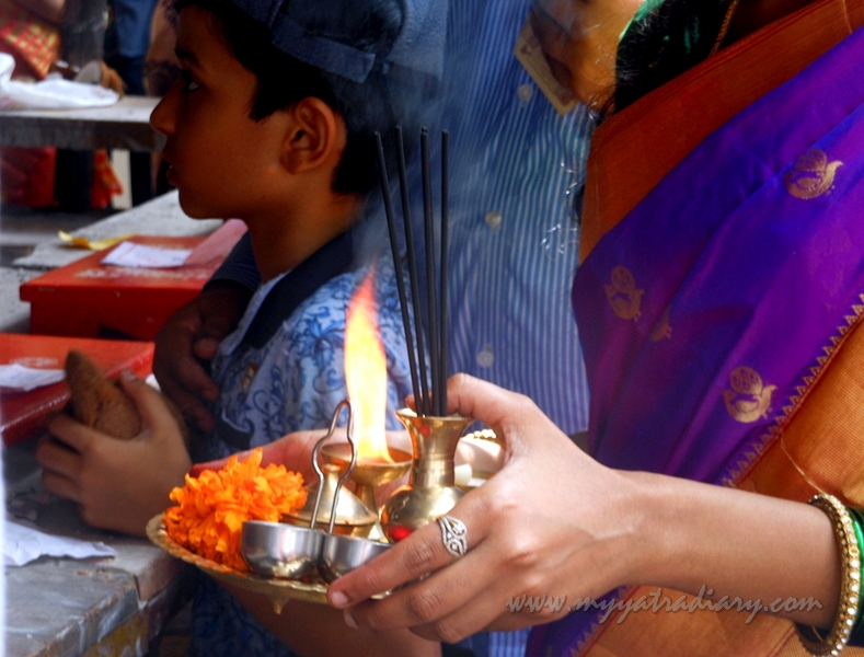 A woman waits to perform aarti, Ganesh Chaturthi Day 1 Mumbai
