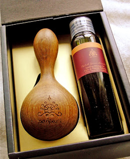 massage oil together with wooden massage tool inside box