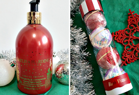a red bottle of handwash and a tube of festive bath fizzers