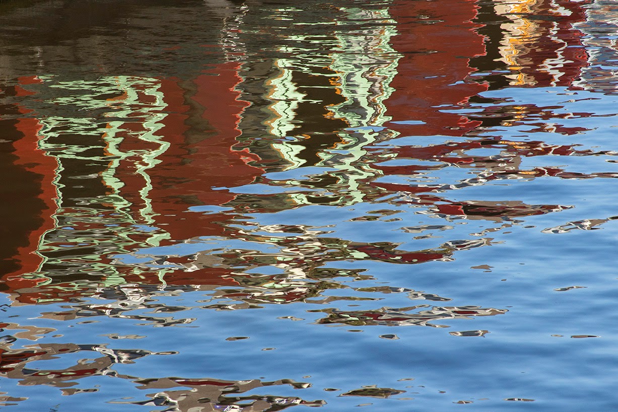 reflection of red canal boat