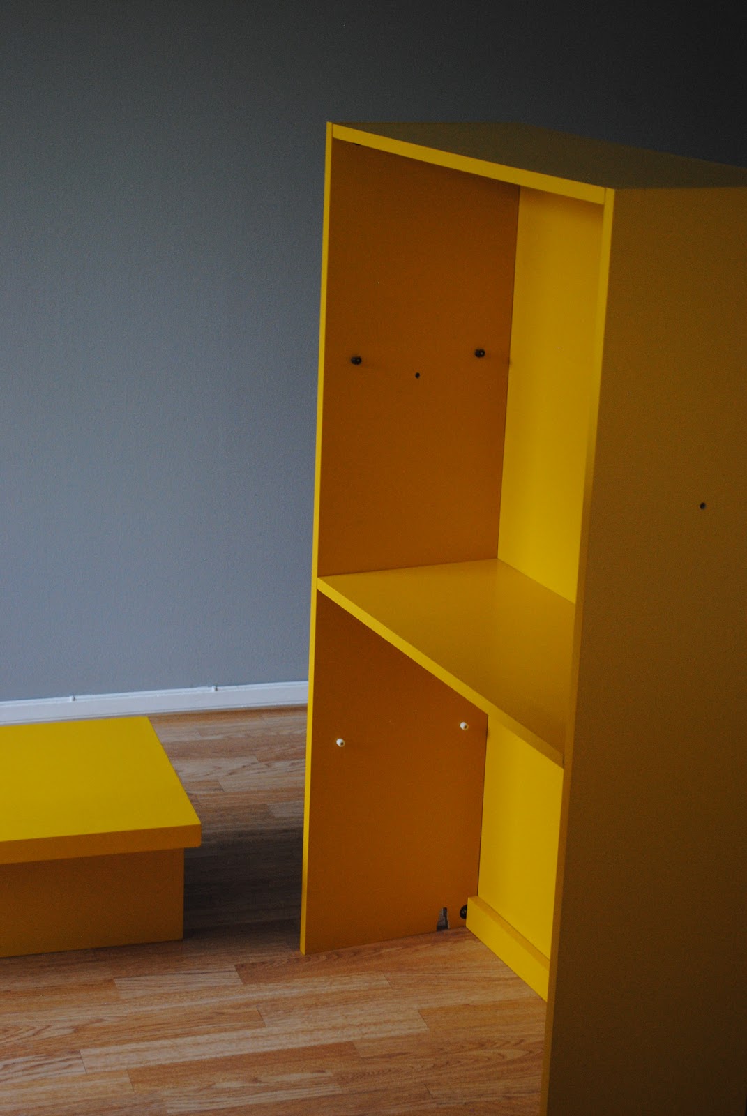 .storm in a tea cup. The yellow bookshelf.