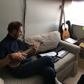 man playing the ukulele