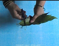 cutting the stalks of leaves to get elements of equal length maavilai-thoranam-1.jpg