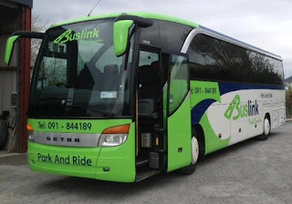 Lime green, blue and white paintwork on a Park and Ride luxury coach, seen from the front