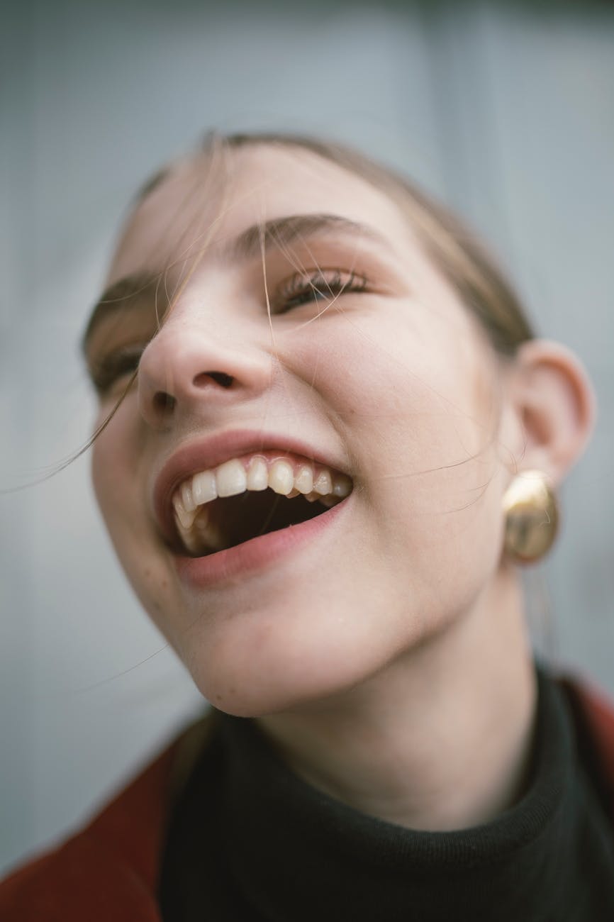 Close-Up Photography of a Laughing Woman