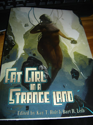 Cover of the Fat Girl In A Strange Land anthology, a fat woman in a space suit floating amongst rocks