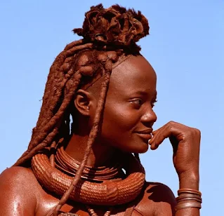 A young Himba woman wearing her erembe headdress of a married woman. Photo Copyright Carol Beckwith & Angela Fisher 1994 from the collection of African Ceremonies.