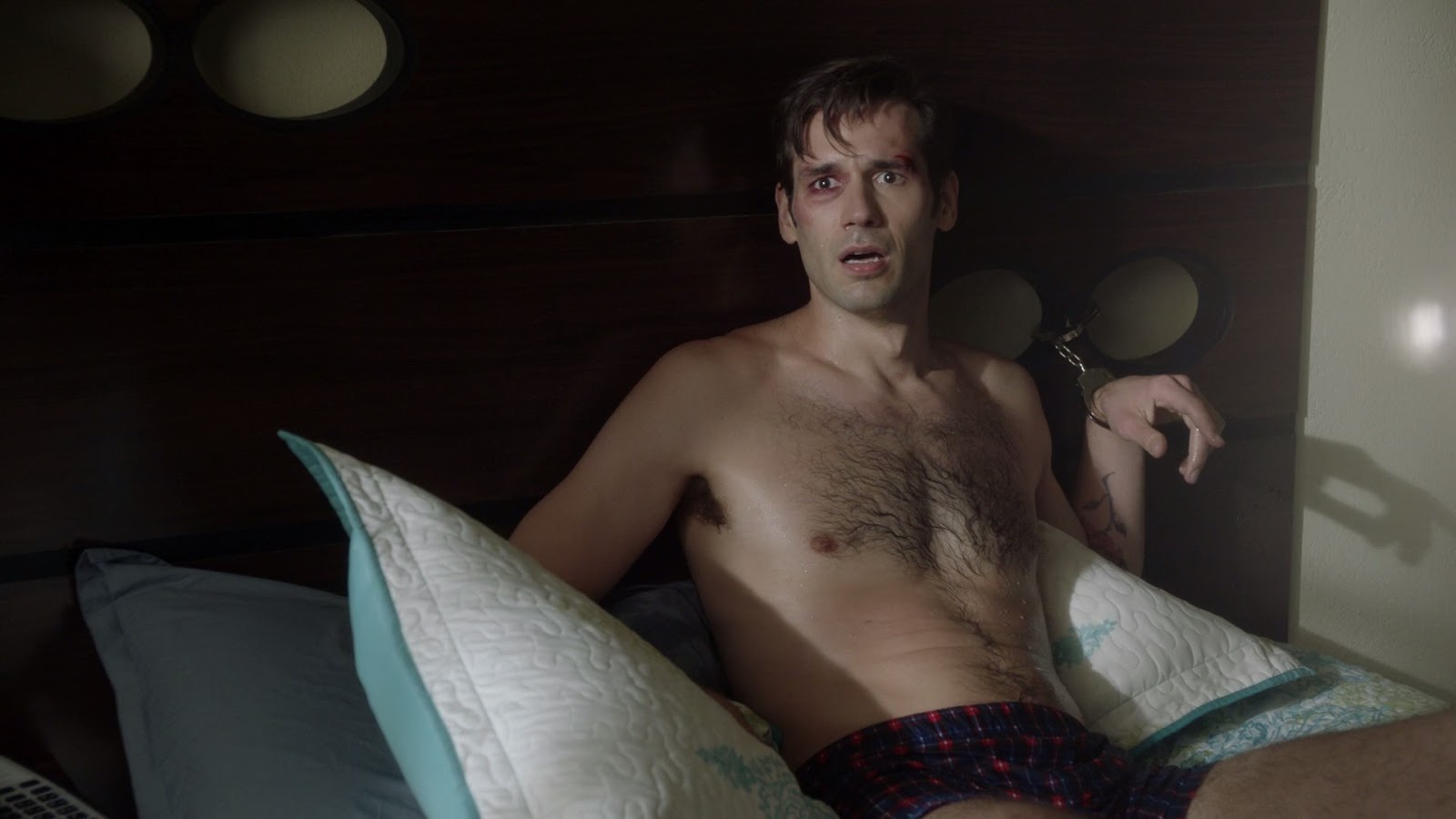 Keywords: handcuffed to bed, shirtless. 