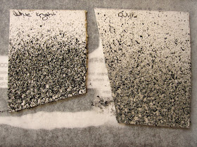 Two sample pieces of carboard, painted with different brands of concrete-looking paint.