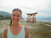 American visitor at O-torii Gate of Itsukushima Shrine at low tide, Miyajima Island, Japan