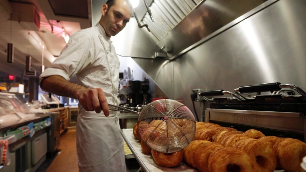 In this June 3, 2013 file photo, chef Dominique Ansel makes Cronuts, a croissant-donut hybrid, at the Dominique Ansel Bakery in New York. (Richard Drew / AP Photo)