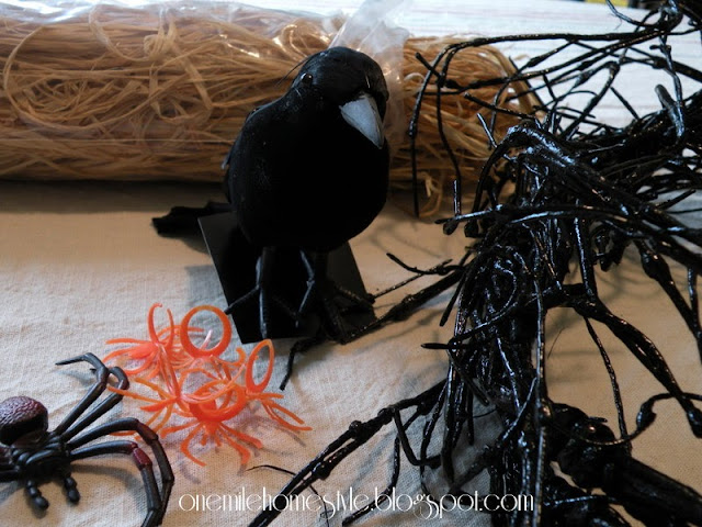 Black crow and plastic spiders for Halloween wreath