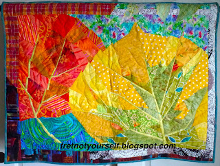 Original quilt - two aspen leaves in orange and yellow against a bright blue background