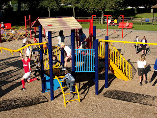 monkey bars and rings and curly yellow slide