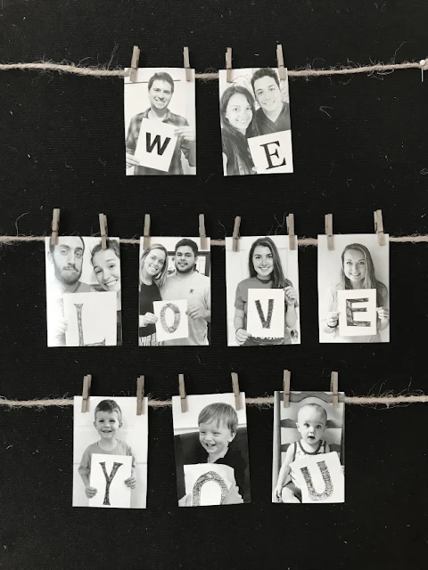 Photos of all the grand children hung with clothespins on string "We love you"