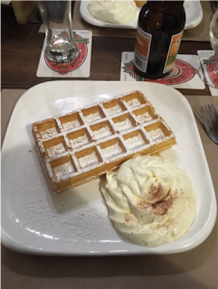 Photo of a Belgian waffle served with powdered sugar and whipped cream. (Belgian waffles are mentioned in the final paragraph.)