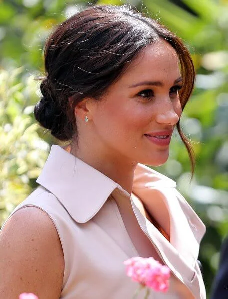 Meghan Markle wore a double breasted trench dress by Banana Republic and suede pumps by Stuart Weitzman