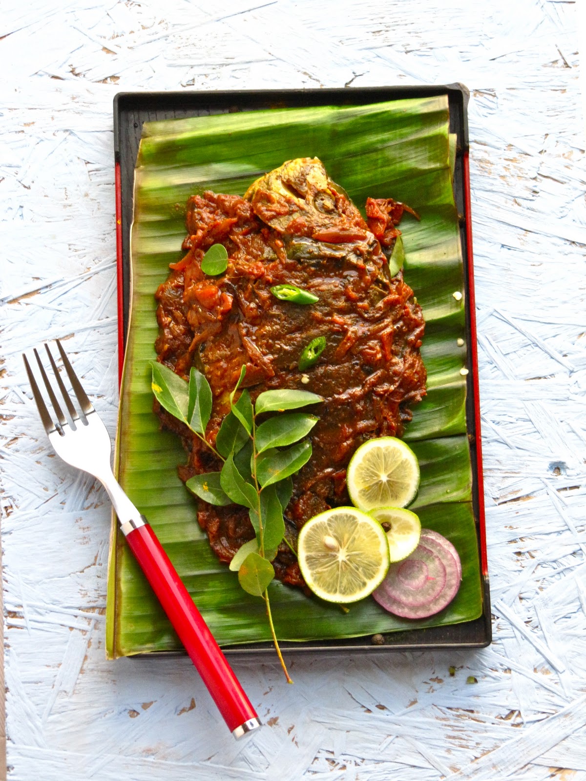 Plateful Karimeen pollichathu — Pearlspot fish grilled in banana leaf