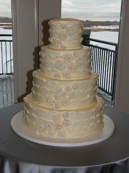 4-tier round buttercream with fondant flowers