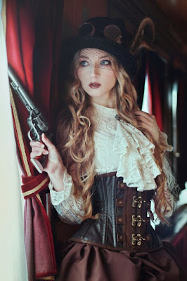 This is an example of how to use an underbust corset in women's steampunk fashion. this woman is wearing her underbust corset with a lace blouse, skirt, hat and goggles.