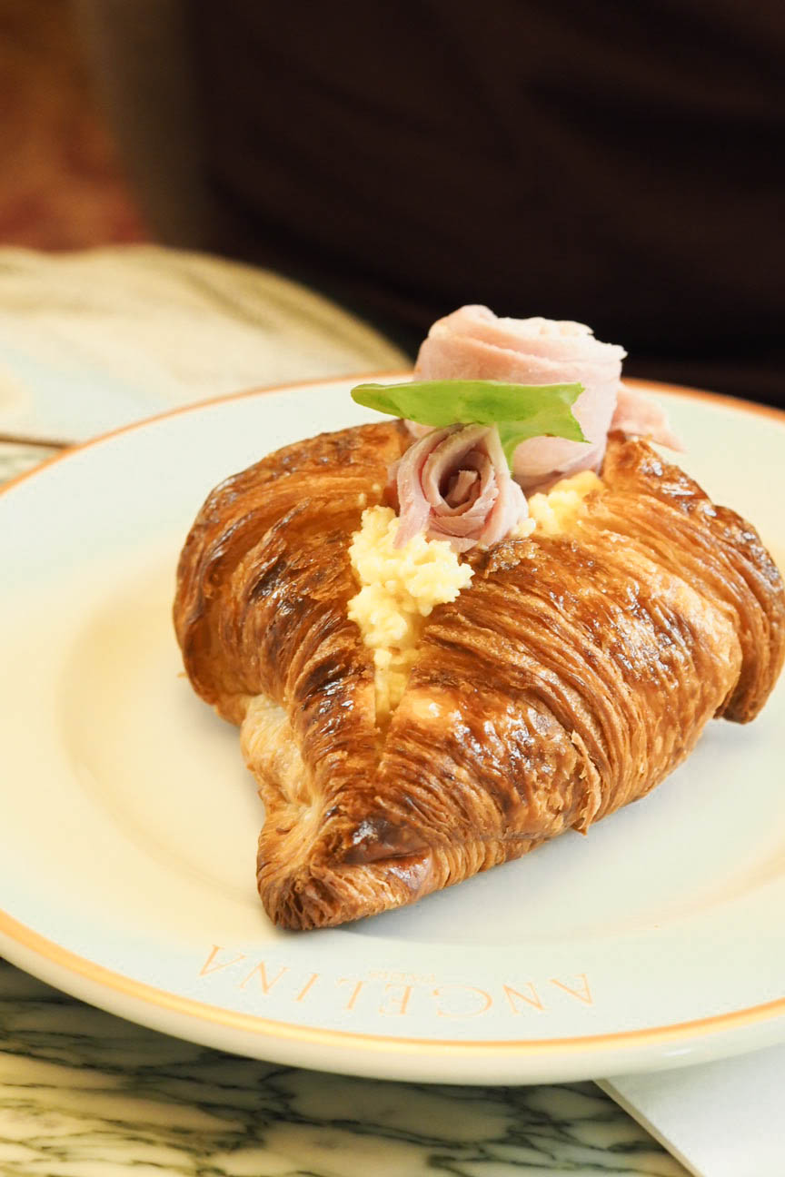Croissant stuffed with scrambled egg and ham