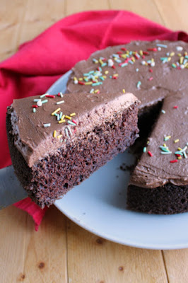 Rich and moist chocolate mayonnaise cake with simple chocolate frosting in a smaller size. It's a perfect dessert for a small party or just because! first slice of chocolate cake being lifted out