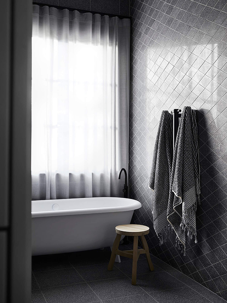 Contemporary bathroom with gray tiles designed by Studio Griffiths, styling by Studio Moore and photo by Sharyn Cairns