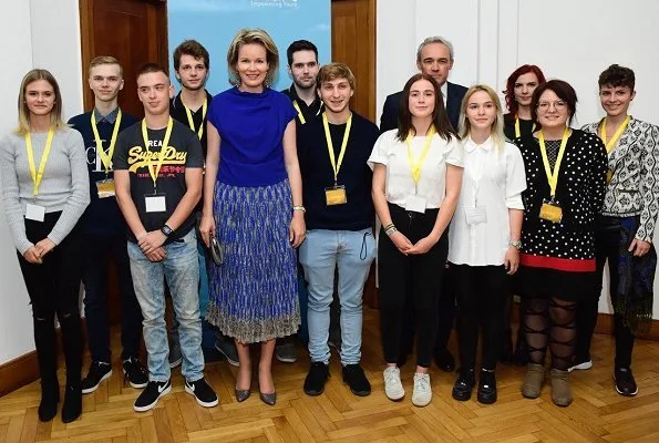 Queen Mathilde wore CEDRIC CHARLIER Asymmetric Striped Metallic Knitted Midi Dress. Provincial Hotel School in Saint-Ghislain