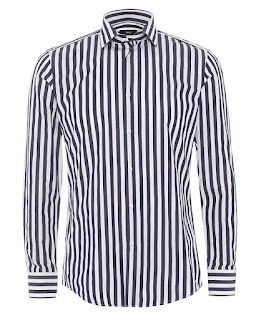A long white shirt with two buttopns open with black thin stripes down the shirt on a white background. 