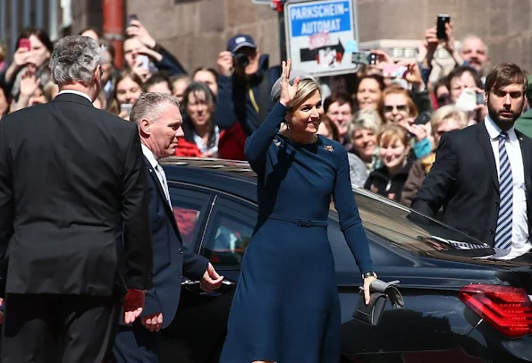 King Willem-Alexander and Queen Maxima of the Netherlands cross the Townhall square