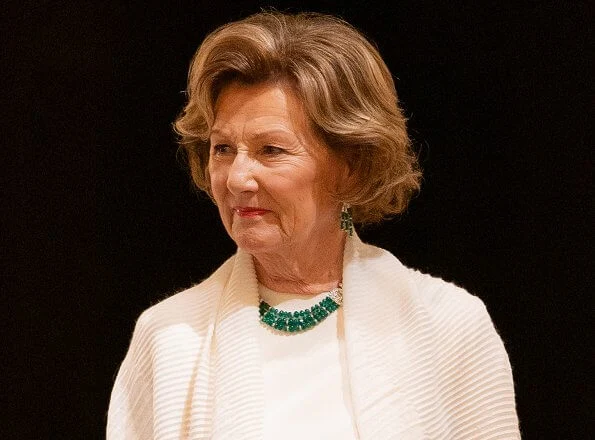 Satin blouse. Queen Sonja wore gold diamonds and emerald necklace. Queen Sonja wore gold and diamond leaf earrings.