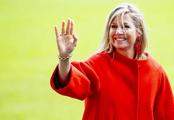 Queen Maxima wore a red top by Natan, and a Natan red wool coat at The Money Wise Platform