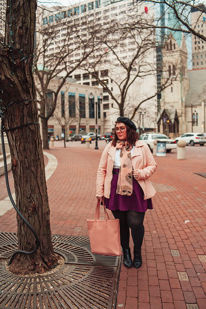 An outfit of a black beret, pink peplum faux leather jacket, vintage white pleated blouse, pink geometric skull print scarf tied in a bow, purple skater skirt, black tights and black boots.