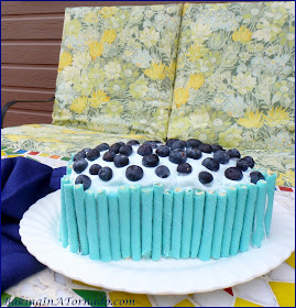 Berry Blue Angel Poke Cake, an angel food loaf infused with blueberries and raspberry liqueur then frosted with flavored whipped cream. | Recipe developed by www.BakingInATornado.com | #recipe #dessert #cake #blueberries