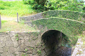 A small, stone, arched bridge